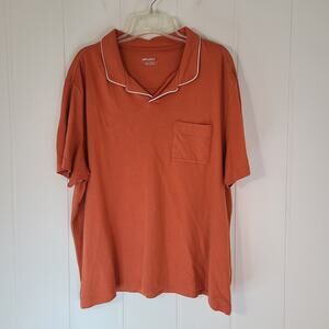 UNTUCKit Altavia Johnny Collar men's polo shirt in orange with white piping.